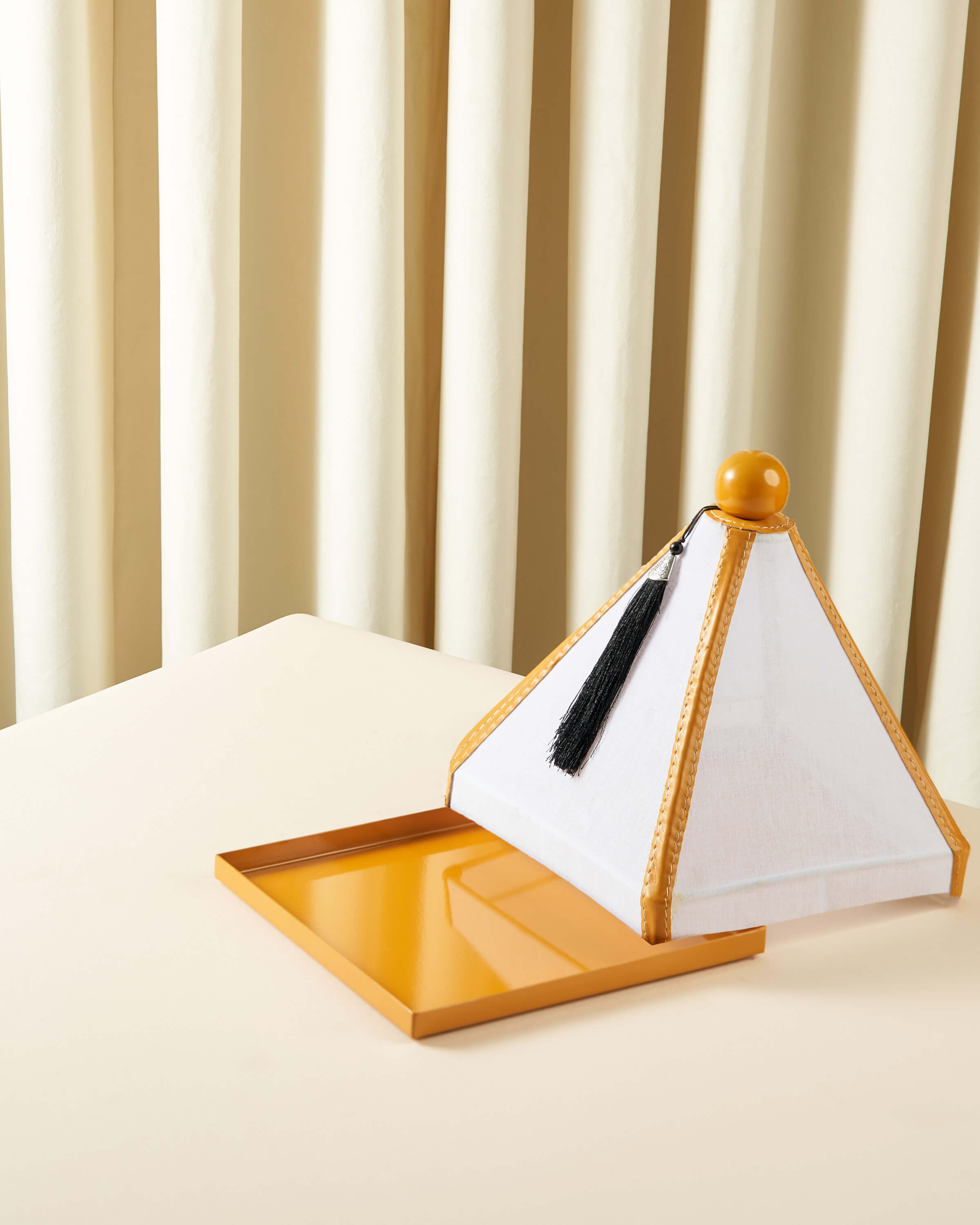 Serving dish with a raw lid and square leather cover