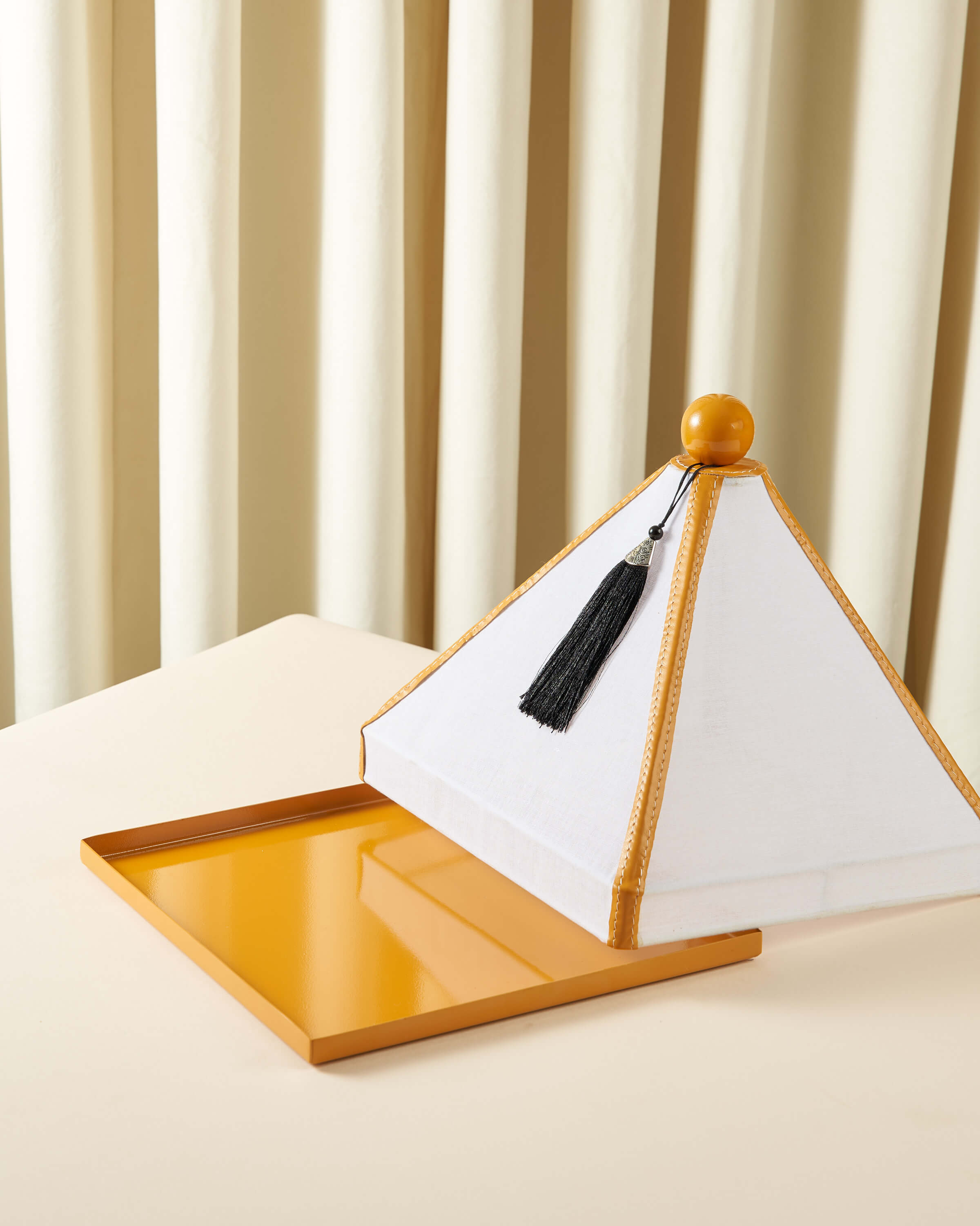 Serving dish with a raw lid and square leather cover